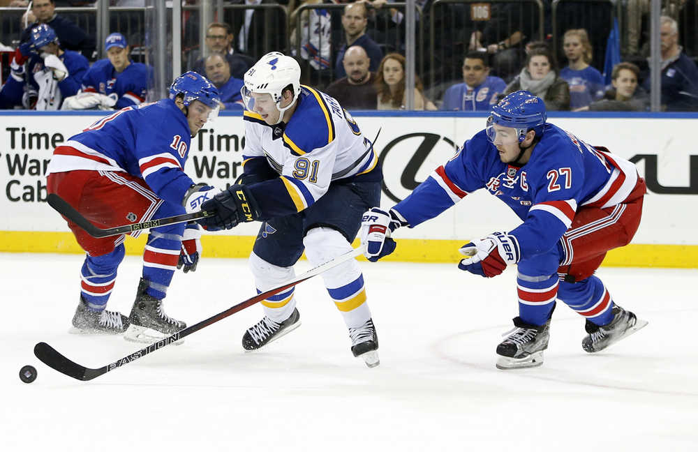 New York Rangers defenseman Ryan McDonagh (27) steals the puck from St. Louis Blues right wing Vladimir Tarasenko (91), of Russia, as Rangers center J.T. Miller (10) looks on in the third period of an NHL hockey game in New York, Thursday, Nov. 12, 2015. The Rangers defeated the Blues 6-3. (AP Photo/Kathy Willens)