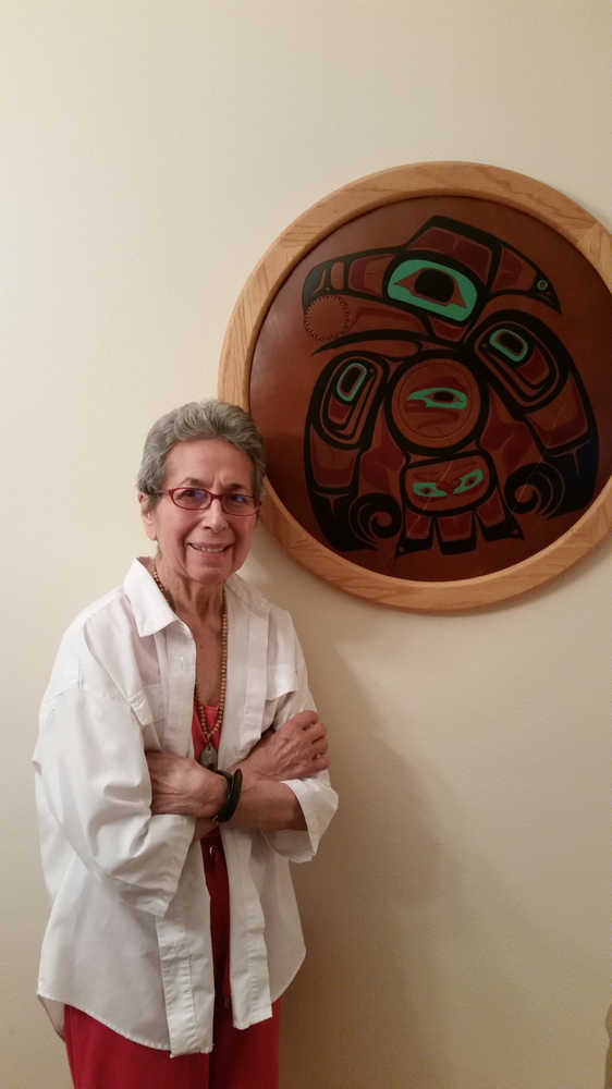 Ethel Lund, Aanwoogex' Shtoo.aak, is shown next to a leatherwork art piece by Steven Evans depicting Raven stealing the sun in her Douglas home on Saturday, Nov. 14.