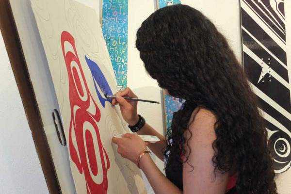Crystal Worl works on a painting at Trickster Gallery during the First Friday Art Walk in August 2015.
