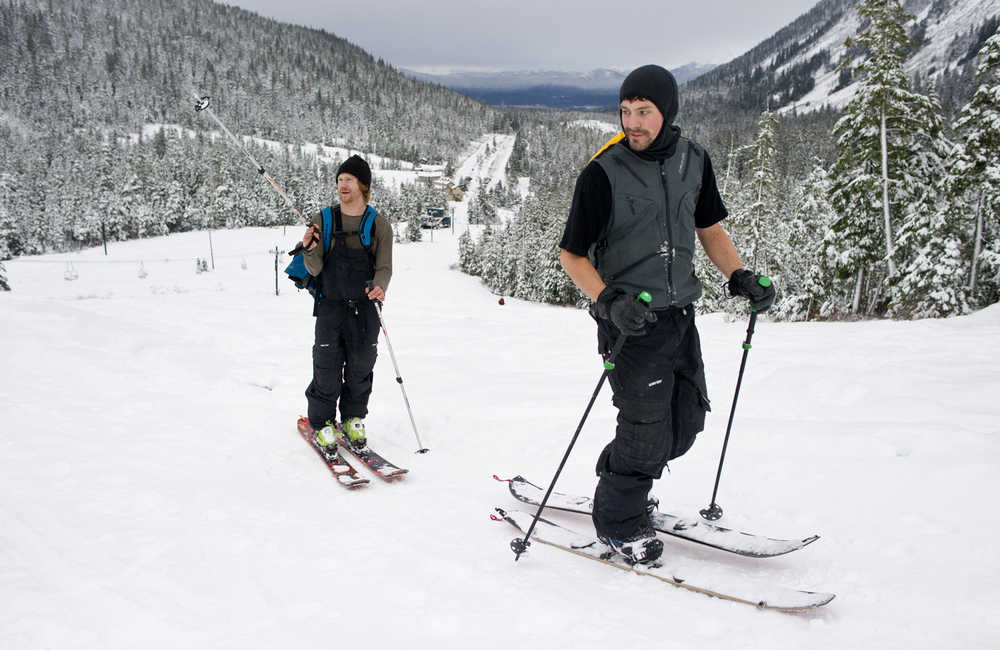 David McCaslind, right, and Michael Blume take advantage of the fresh snow to skin up Eaglecrest on Monday.