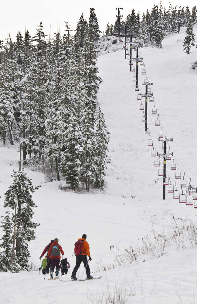 Skiers skin up through fresh snow at Eaglecrest on Monday.