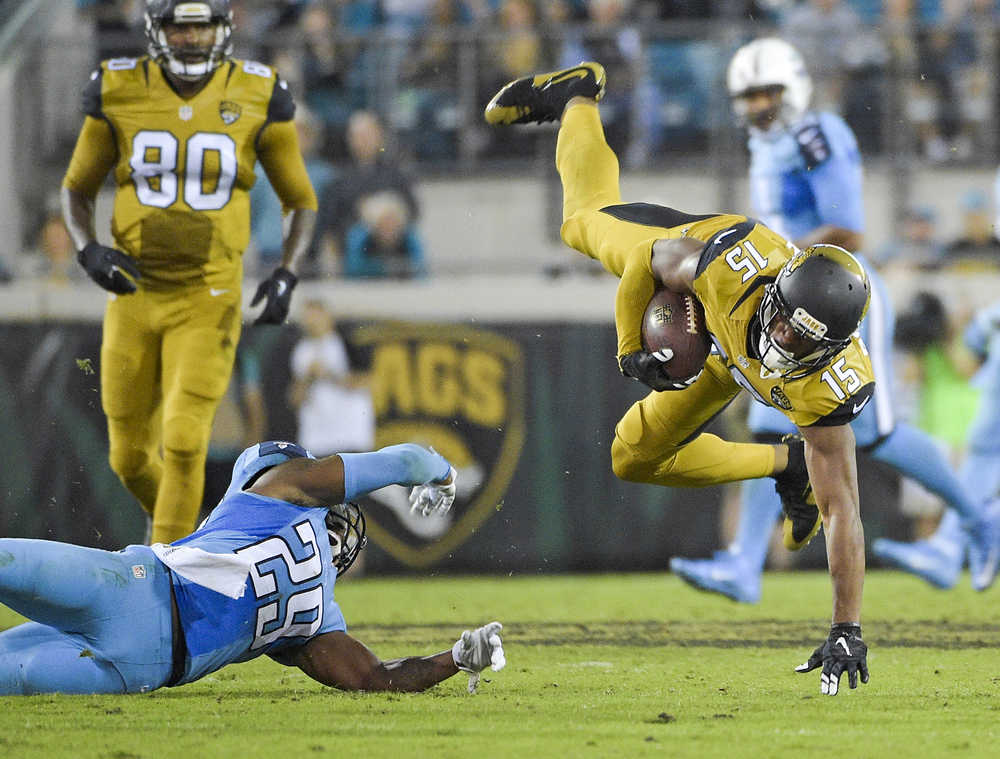 Tennessee Titans cornerback Perrish Cox (29) stops Jacksonville Jaguars wide receiver Allen Robinson (15) after a reception during the second half of an NFL football game in Jacksonville, Fla., Thursday, Nov. 19, 2015.(AP Photo/Phelan M. Ebenhack)