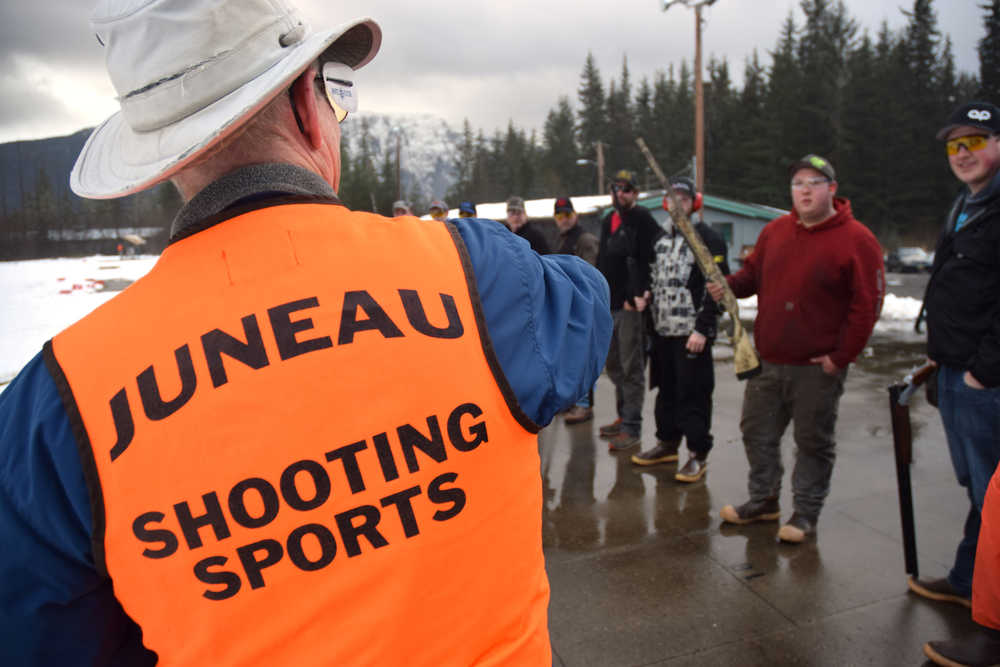 Shooters listen to a range safety officer explain the rules of the Annie Oakley contest on Saturday, Nov. 21, 2015 during the Juneau Gun Club's annual Turkey Shoot fundraiser. During the Annie Oakley, a line of shooters is invited to fire shotguns in sequence at clay pigeons. If a shooter misses the pigeon, he is eliminated if the next shooter in line can destroy the flying target. Juneau Shooting Sports is a co-sponsor of the event with the Gun Club.
