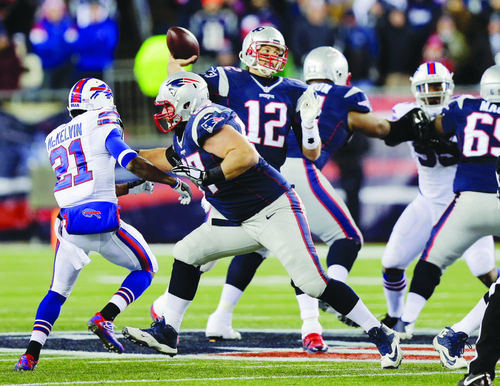 New England Patriots quarterback Tom Brady (12) passes against the rush by Buffalo Bills safety Leodis McKelvin (21) in the first half of an NFL football game, Monday, Nov. 23, 2015, in Foxborough, Mass. (AP Photo/Charles Krupa)