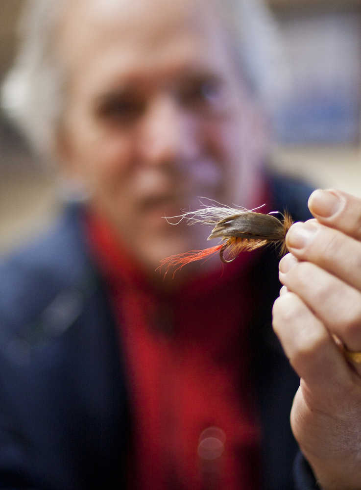 Rob Bosworth, of Juneau, holds up a "cactus fly" tied by his father, Dr. Bob Bosworth, in 2010. While the fly might look like a typical tool of any fly fisherman, the hook is anything but usual. The hook is a barb from the Fish Hook Barrel Cactus, which grows in deserts such as those in Arizona. Read more on this story by searching with web for "Cactus Fly."