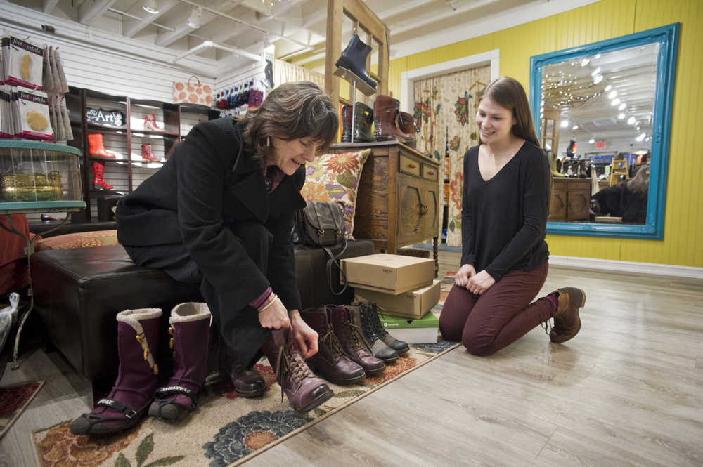 Laurel Messerschmidt, right, helps Chiska Derr find a pair of new boots at Shoefly on Tuesday.