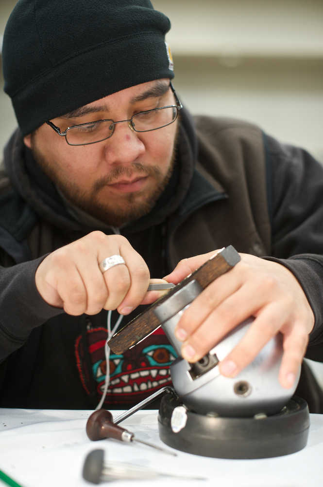 Samuel Sheakley, Sr., works on a silver piece at the Native Artists Market in the Elizabeth Peratrovich Hall in Nov. 2014.