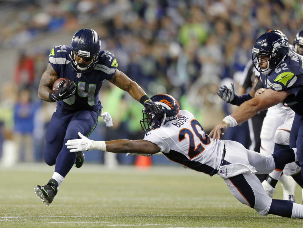 FILE - In this Friday, Aug. 14, 2015,file photo, Seattle Seahawks running back Thomas Rawls carries the ball as Denver Broncos defensive back Josh Bush attempts a tackle in the second half of a preseason NFL football game in Seattle. "He's done very well and been consistent," Seahawks coach Pete Carroll says of Rawls. "Whenever he's been given a real good shot, he's come through in a big way." The Seahawks face the Pittsburgh Steelers this week. (AP Photo/John Froschauer, File)