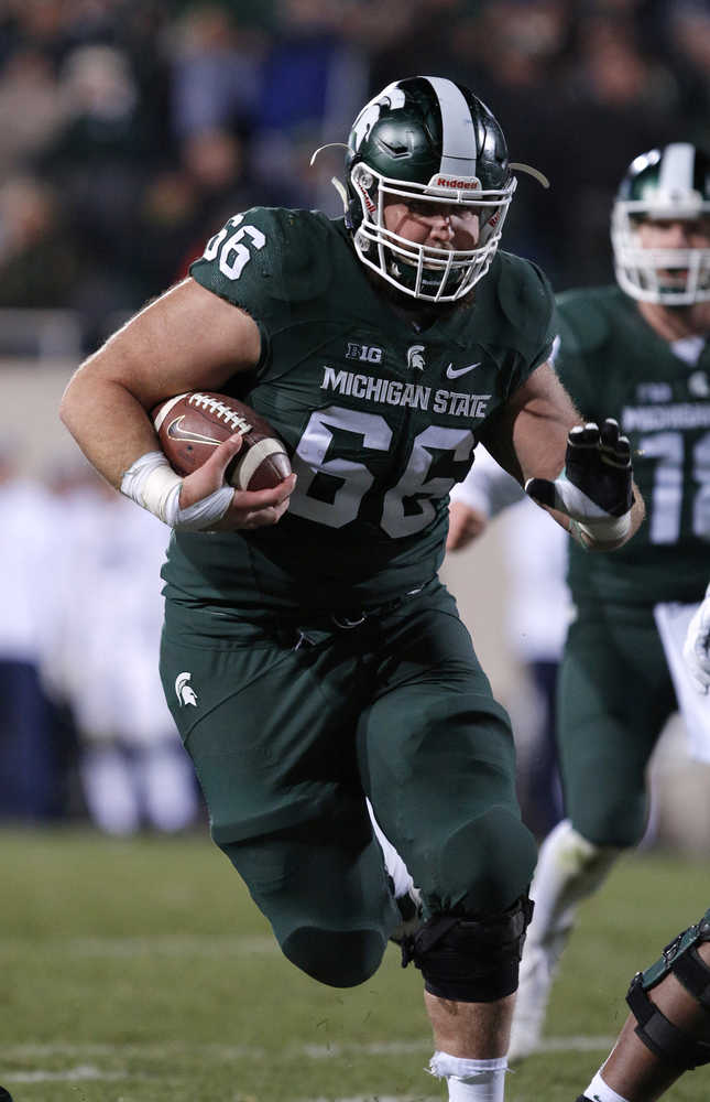 Michigan State offensive lineman Jack Allen runs for a nine yard touchdown against Penn State during the fourth quarter of an NCAA college football game, Saturday, Nov. 28, 2015, in East Lansing, Mich. Michigan State won 55-16. (AP Photo/Al Goldis)