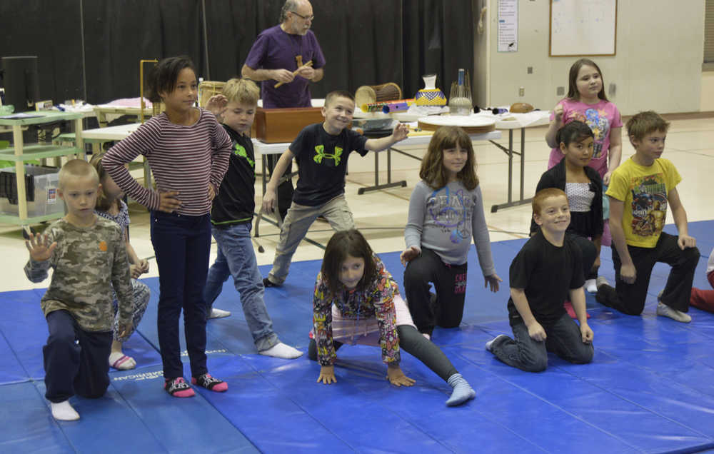 In this Nov. 13 photo, third grade students in Krista Etzwiler's class at West Homer Elementary School act out an interpretive dance to the sound of artist Eddie Wood's storytelling and percussion in Homer. The performances marked the end of Wood's two week long artist residency at the school.