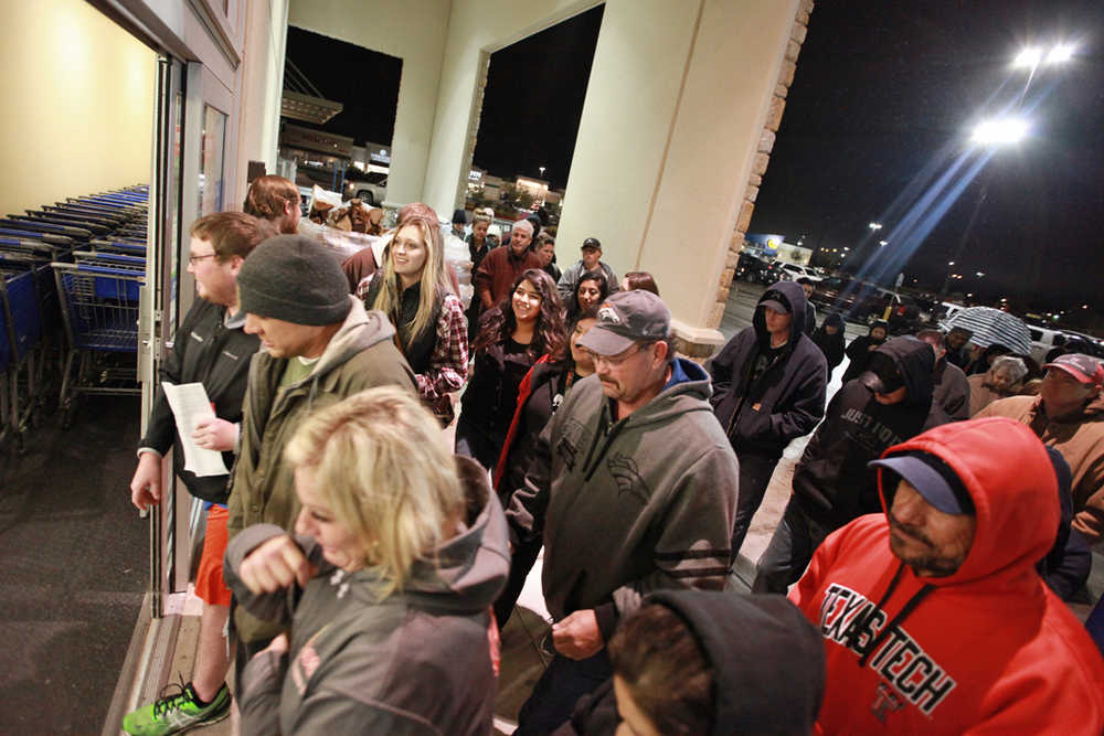 Shoppers rush through the entrance to the Academy Sports+Outdoors at 5 a.m. on Friday in Odessa, Texas.
