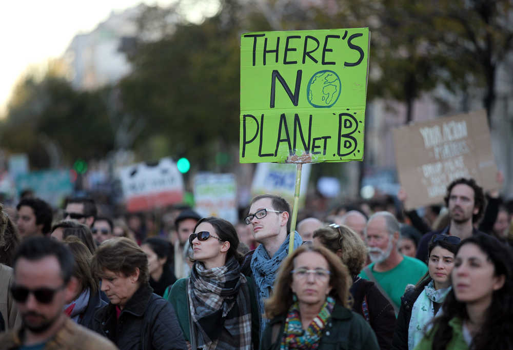 A young man carries a sign "There's no planet B" while taking part in a World Climate March in Lisbon on Sunday.