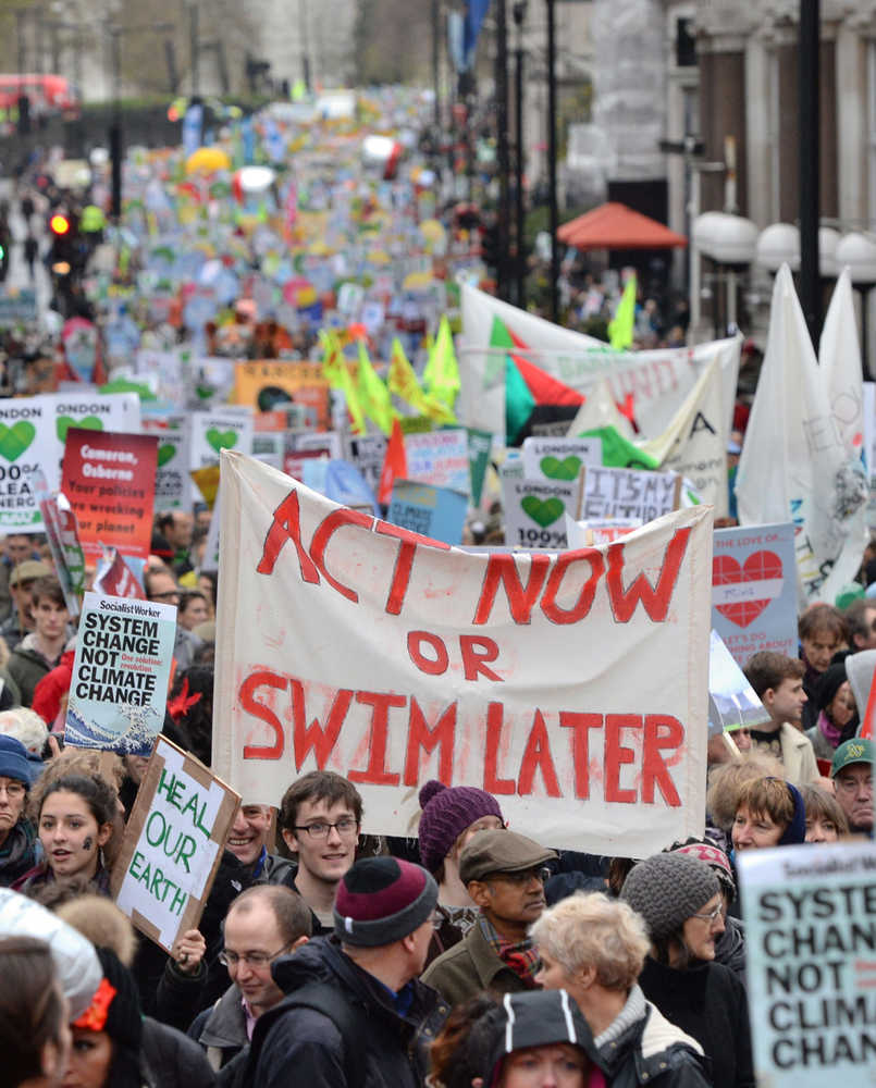 Demonstrators move through the streets of central London campaigning for ambitious action to tackle climate change on Sunday.