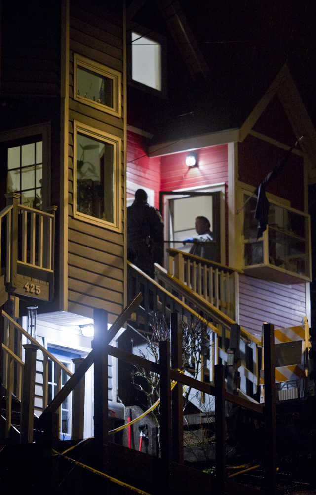 Juneau Police Chief Bryce Johnson talks with detectives at the front door of Mayor Greg Fisk's house on Kennedy Street Monday night.