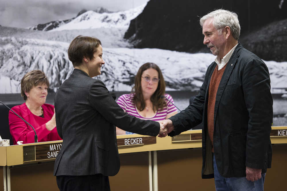 Greg Fisk shakes hands with City Attorney Amy Mead after she swore him in as Mayor before the Assembly on Oct. 20.