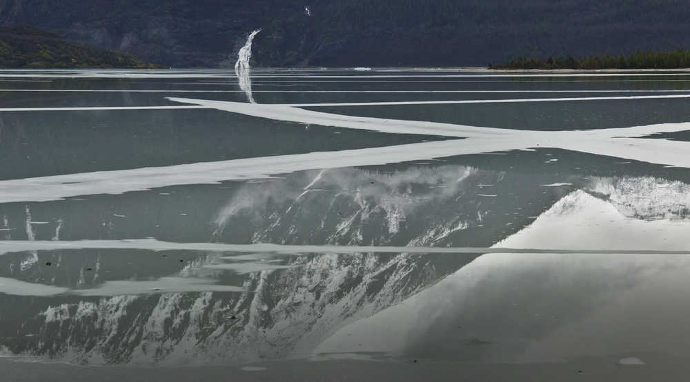 Rain water sits on top of thin ice on Mendenhall Lake on Monday.
