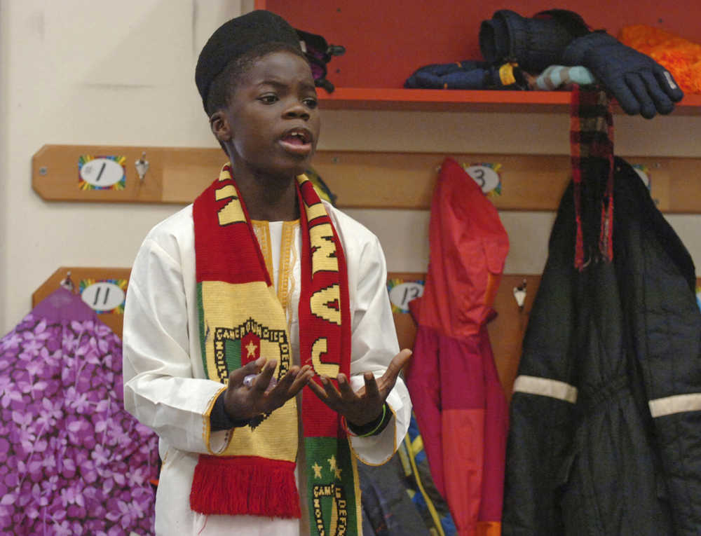 In this Nov. 25 photo, exchange student Nouredine Mama, of Cameroon, shares details about his culture and life in Africa with fourth and sixth grade students at Nikolaevsk School in Nikolaevsk.