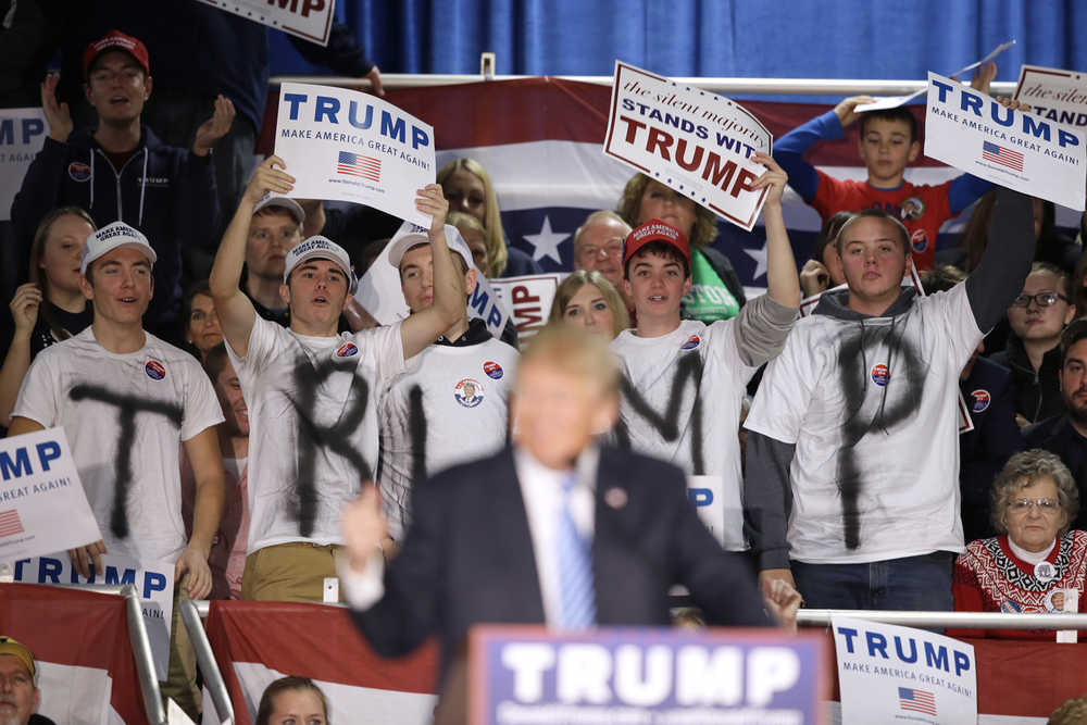 Supporters react as Republican presidential candidate Donald Trump speaks during a campaign rally, Saturday, Dec. 5, 2015, in Davenport, Iowa. (AP Photo/Charlie Neibergall)