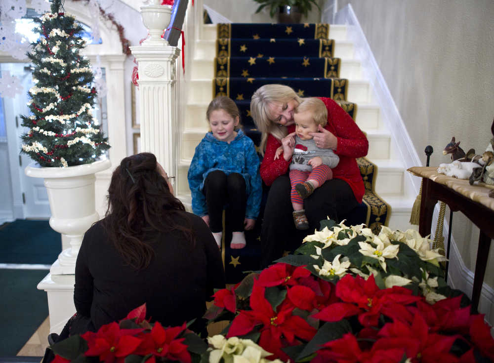 First Lady Donna Walker spends time with her grandchildren, Walker Linderman, 11 months, and Mera Hobson, 7, as they wait for the doors to open for the Governor's Open House on Tuesday.