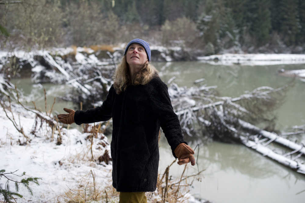 Sonia Nagorski, assistant professor of Geology Arts and Sciences at the University of Alaska Southeast, looks at leaning trees along the bank of the Mendenhall River on Tuesday. The river is nearing the point of cutting through a meander bend just north of the Brotherhood Bridge.