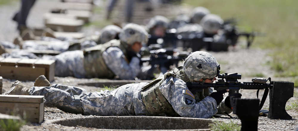 FILE - In this Sept. 18, 2012 file photo, female soldiers training on a firing range while wearing new body armor in Fort Campbell, Ky. Members of the U.S. special operations forces say that allowing women to serve in Navy SEAL, Army Delta or other commando units could hurt their effectiveness, lower the standards and drive men away from the jobs. The troops told a Rand Corp. survey that they believe women don't have the physical strength or mental toughness to do the grueling jobs. And their message to political leaders is that when they are fighting in the shadows or bleeding on the battlefield, women have no place on their teams.  (AP Photo/Mark Humphrey, File)
