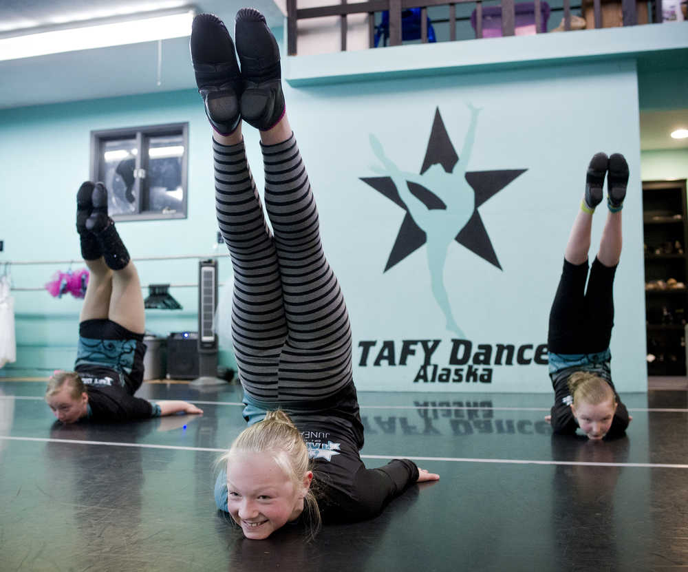 Teslyn Harris, left, Denali Isaak, center, and Sophia Owen of the TAFY Dazzlers dance group practice their "Black Magic" routine at the TAFY Dance Studio on Thursday. The TAFY Dancers, lead by Director Mika Morford, perform their winter showcase at the Thunder Mountain High School auditorium this Saturday at 2 and 6 p.m.