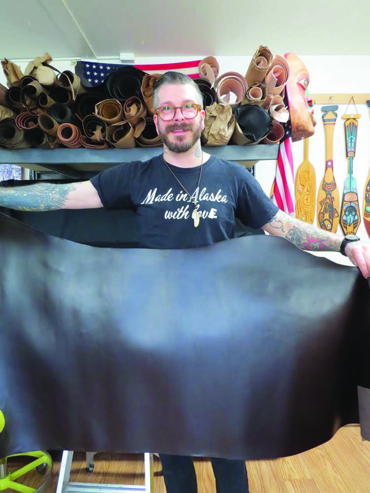 Dan Ewing holds a hide he'll use to create some of the leather products he sells at Ewing Dry Goods.
