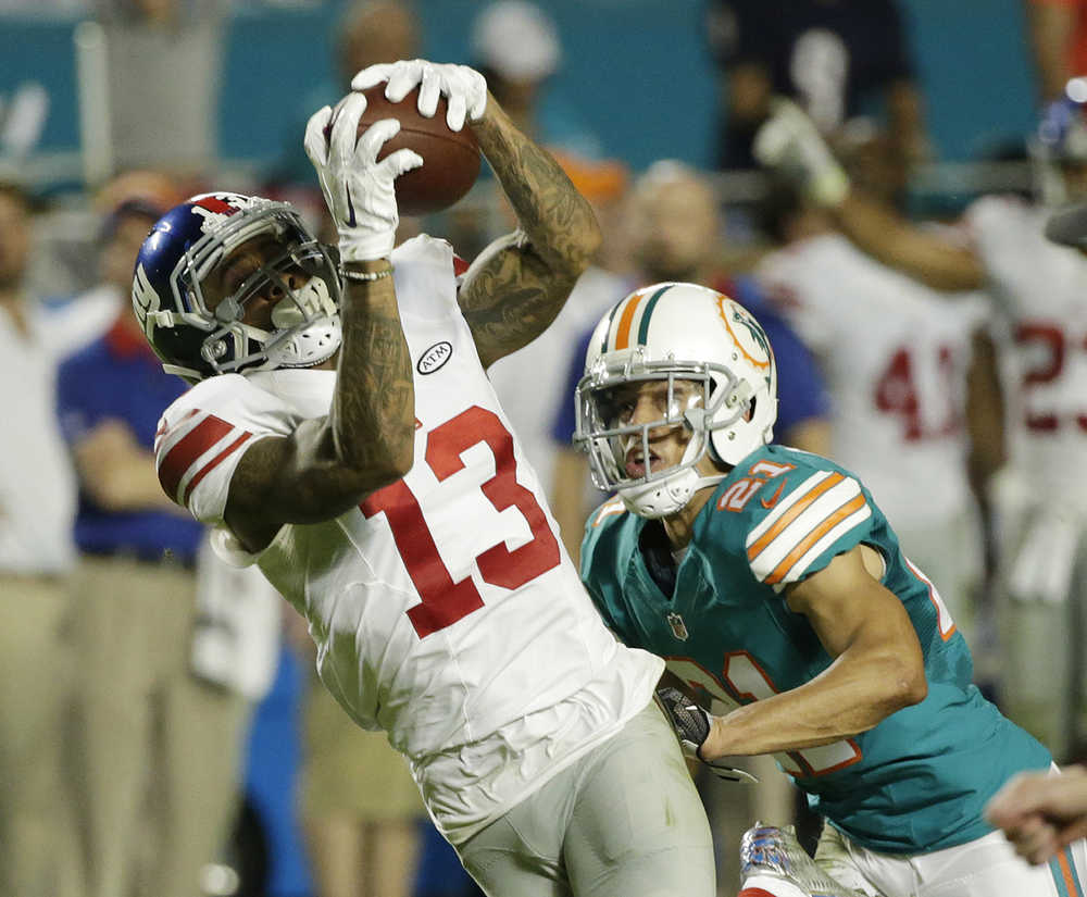 New York Giants wide receiver Odell Beckham makes a catch as Miami Dolphins cornerback Brent Grimes defends Monday.