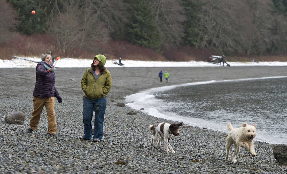 Brenda Vigue, left, and Chailly Clayton exercise their dogs, Olga and Slocum, along the Auke Recreation Area beach on Tuesday.