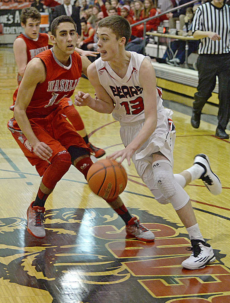 In this January 2015 photo, Juneau-Douglas' Kaleb Tompkins (13) drives past to the basket. Tompkins scored 17 points in JDHS's win Thursday over West High School.