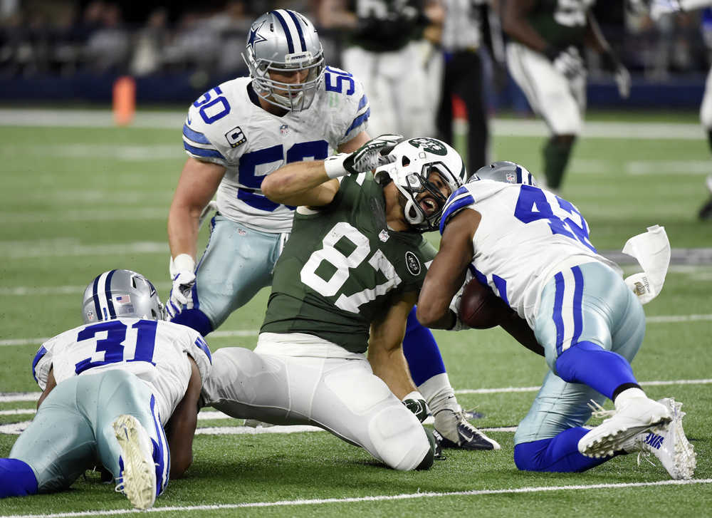 New York Jets wide receiver Eric Decker loses the ball after a catch after being  by Dallas Cowboys' Byron Jones (31) and Barry Church (42) as Sean Lee (50) watches on Saturday in Arlington, Texas.