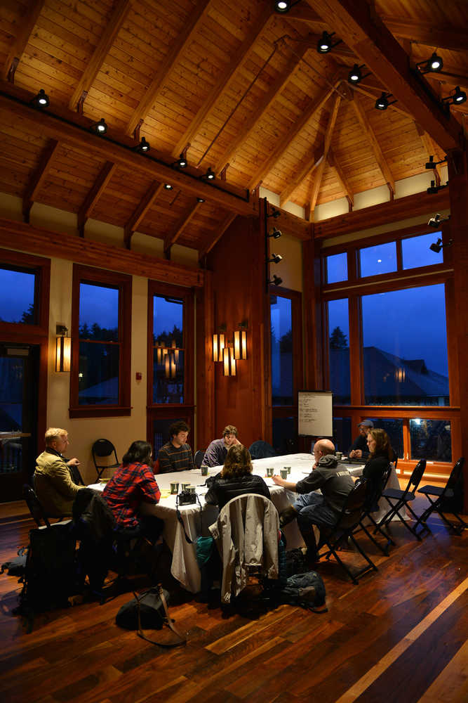 In this photo taken Nov. 12, a group works into the evening to discuss the framework of a new college based on northern California's student-run Deep Springs College model in Allen Hall on the Sheldon Jackson College campus in Sitka.
