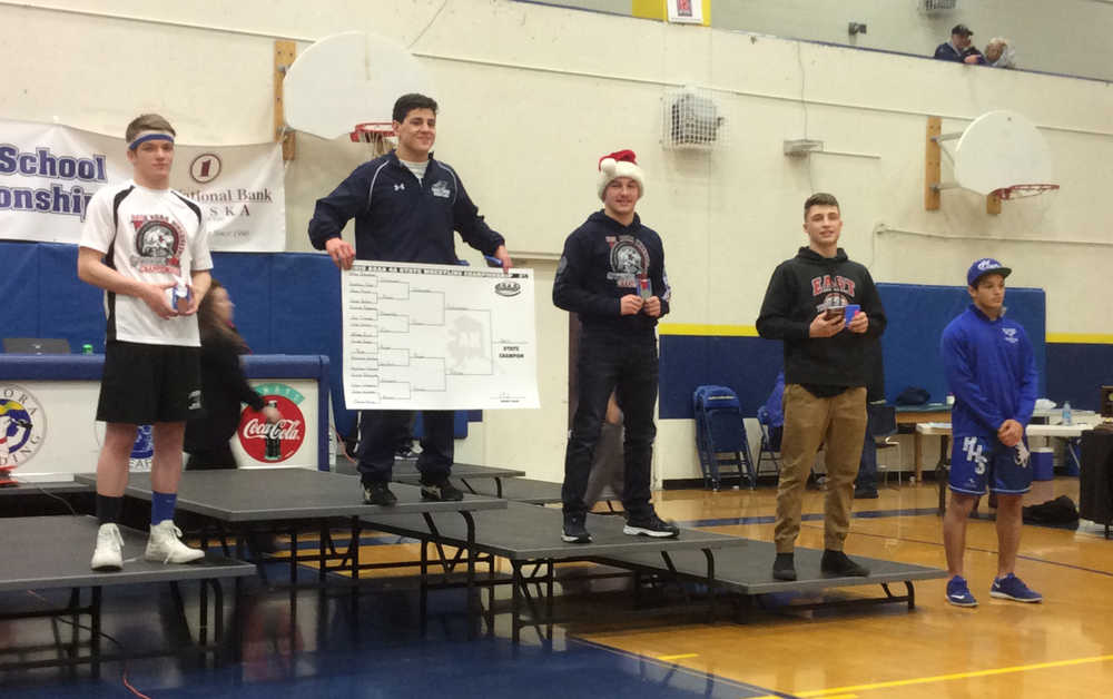 Hunter Boyer, left, stands with other competitors at Bartlett High School on Saturday after finishing third in the 152-pound weight class during the state wrestling tournament.