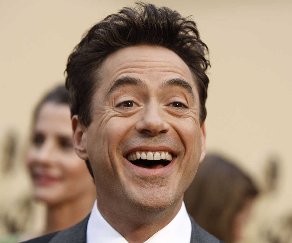 FILE - In this Sunday, Feb. 22, 2009, file photo, Robert Downey Jr. arrives for the 81st Academy Awards in the Hollywood section of Los Angeles. California Gov. Jerry Brown on Thursday, Dec. 24, 2015,  pardoned Downey Jr. for a nearly 20-year-old felony drug conviction that sent the Oscar-nominated actor to jail for nearly a year. The pardon does not erase records of a conviction, but it restores voting rights and is a public proclamation that the person has remained out of trouble and demonstrated "exemplary behavior," according to materials on Brown's website.  (AP Photo/Matt Sayles, File)