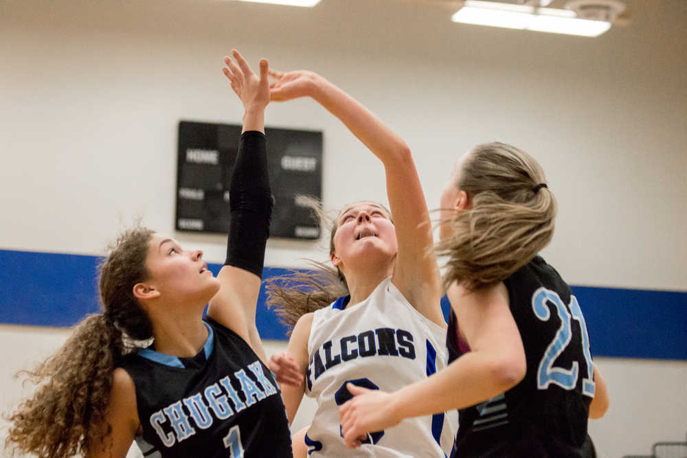 Thunder Mountain's Ava Tompkins and two Chugiak players collide as they go for the ball on Saturday.