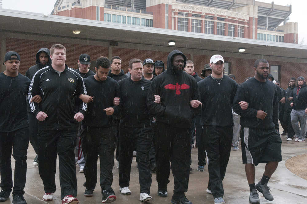 This March 9 photo shows the University of Oklahoma football team and coaches lining up wearing all black in the Everest Training Center in protest of the Sigma Alpha Epsilon fraternity at the University of Oklahoma.