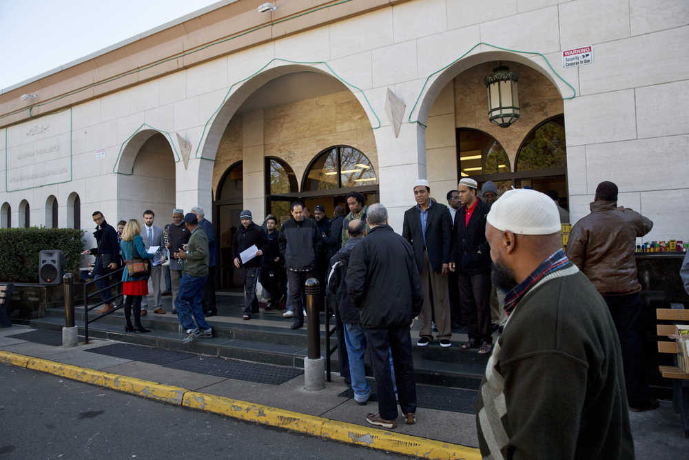 In this photo taken Dec. 4, people arrive for Friday prayers at Dar al-Hijrah Mosque in Falls Church, Virginia.