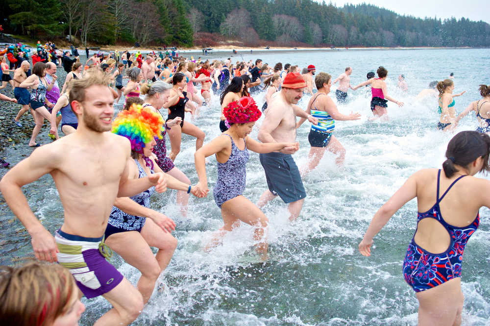 Over 100 people participate in the annual Polar Bear Dip at the Auke Village Recreation Beach on Jan. 1, 2015.