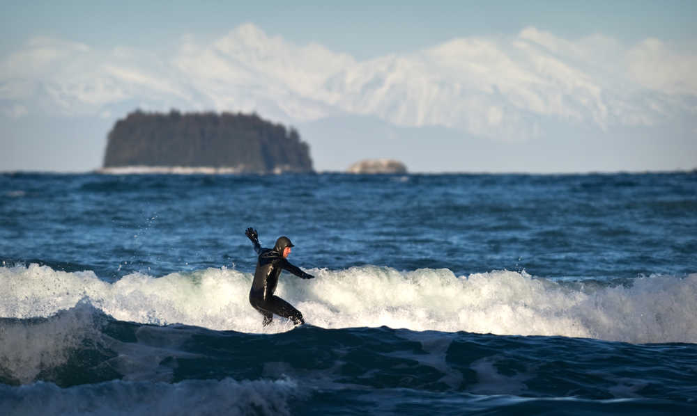 Chris Hinkley takes advantage of high winds from the north to surf off Lena Beach on Feb. 5.