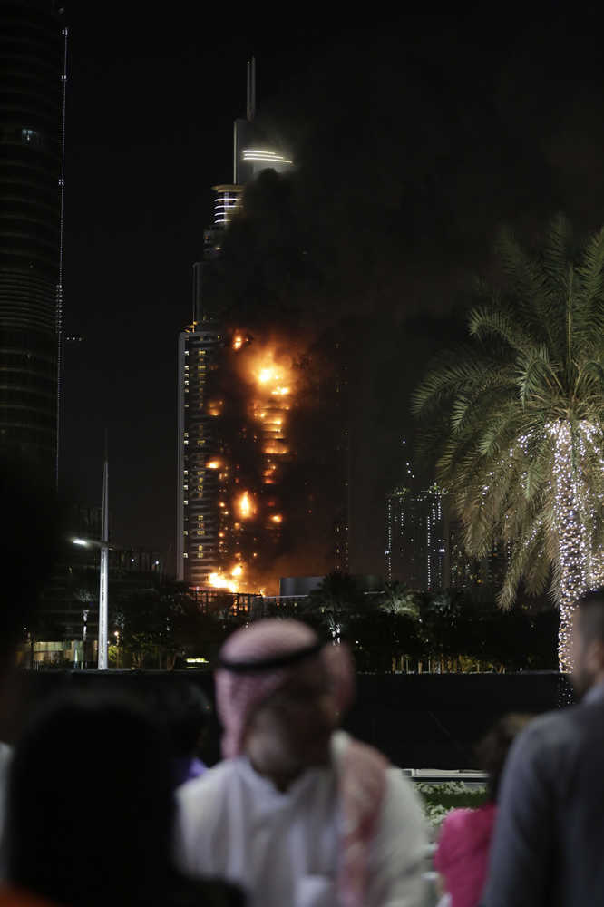 Smoke and flames pouring from a residential building, which also contains the Address Downtown Hotel, in Dubai, United Arab Emirates on New Year's Eve.