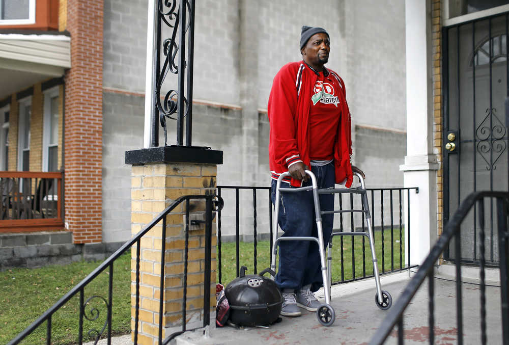 In this Dec. 30photo, Clifton Gerald, a survivor of two instances of gun violence, stands on his front porch in Baltimore.