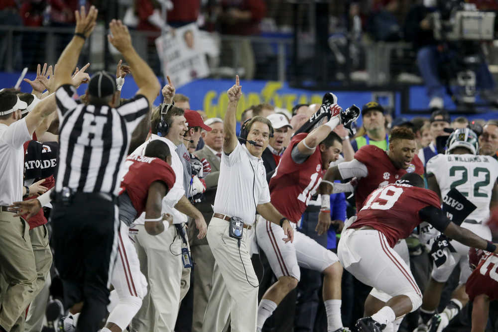 Alabama head coach Nick Saban and team take the field at the end of the Cotton Bowl NCAA college football semifinal playoff game against Michigan State on Dec. 31, 2015. Alabama won 38-0 to advance to the championship game.