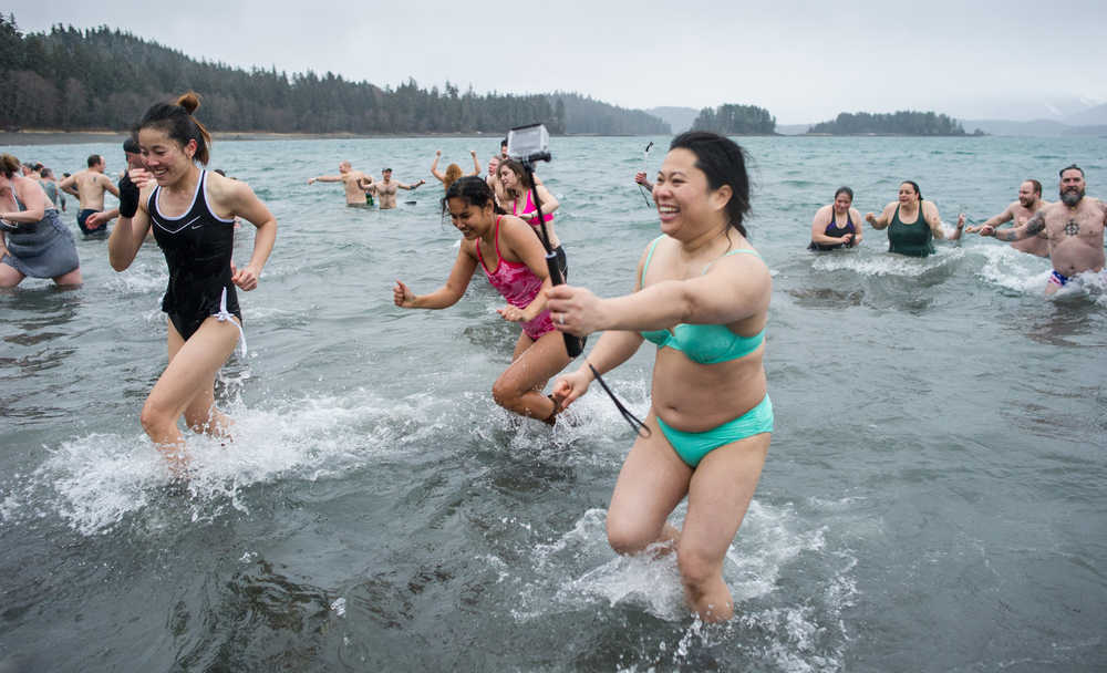 Hundreds of swimmers race from the sea during the 24th annual Polar Bear Dip at the Auke Village Recreation Area on Friday, Jan. 1, 2016.