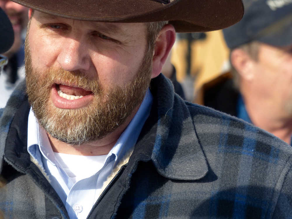 Ammon Bundy chats with a protester Saturday during a march on behalf of a Harney County ranching family in Burns, Oregon.