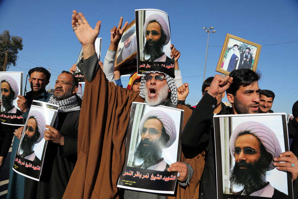 Iraqi Shiite protesters chant slogans against the Saudi government as they hold posters showing Sheikh Nimr al-Nimr, who was executed in Saudi Arabia last week, during a demonstration in Najaf, 100 miles (160 kilometers) south of Baghdad, Iraq, Monday, Jan. 4, 2016. Demonstrations against the al-Nimr execution and Saudi Arabia are also being called for in the predominantly Shiite southern cities on Monday. (AP Photo/Karim Kadim)