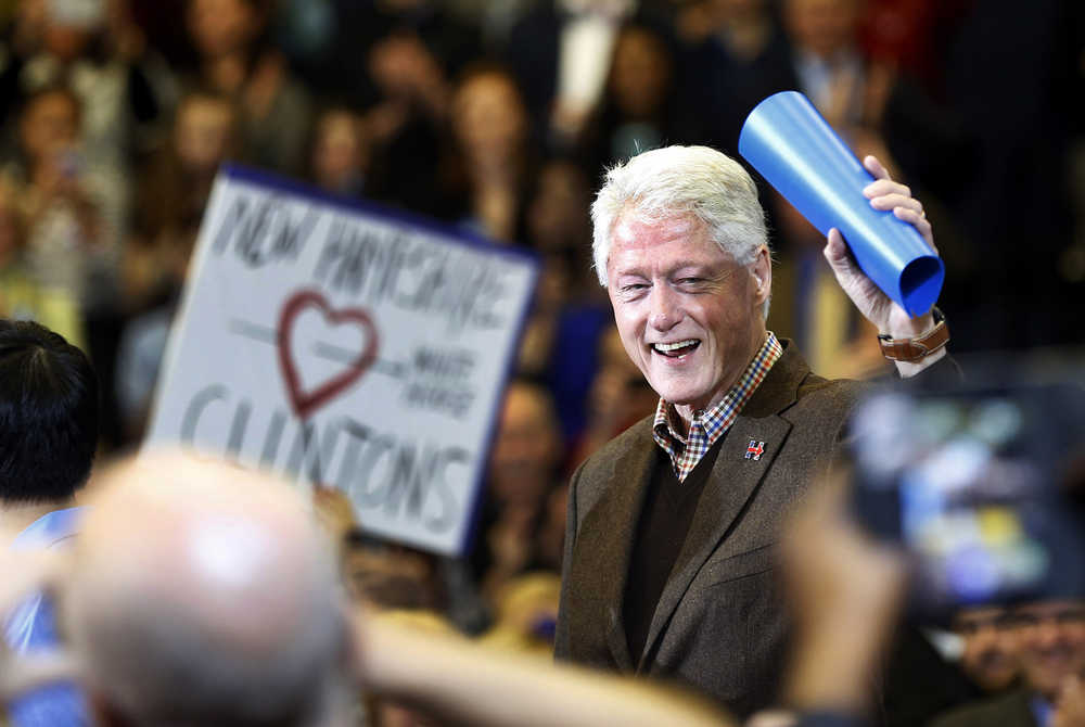 Former President Bill Clinton waves to a cheering crowd as he arrives during a campaign stop for his wife, Democratic presidential candidate Hillary Clinton, Monday, Jan. 4, 2016, in Nashua, N.H. (AP Photo/Jim Cole)