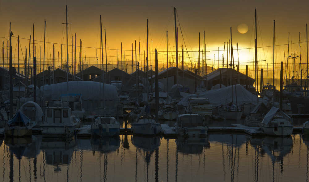 The sun is seen rising over Aurora Harbor on Tuesday.
