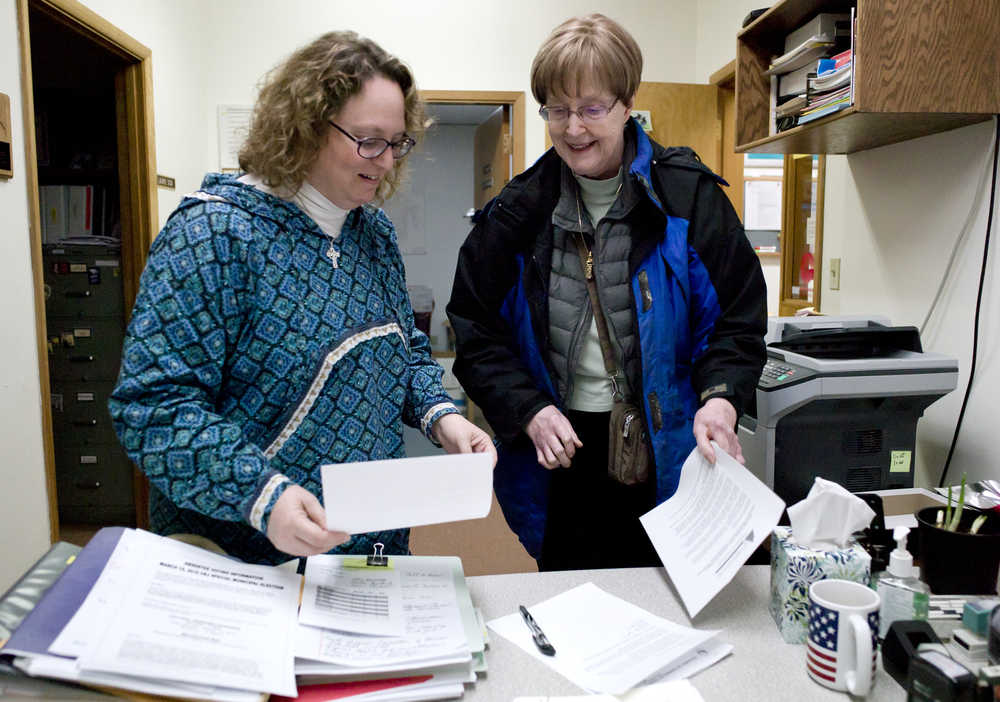 Cheryl Jebe, right, turns her paperwork to apply for the District 1 Assembly seat with Deputy Clerk Beth McEwen at City Hall just in time for the 4:30 deadline on Tuesday.