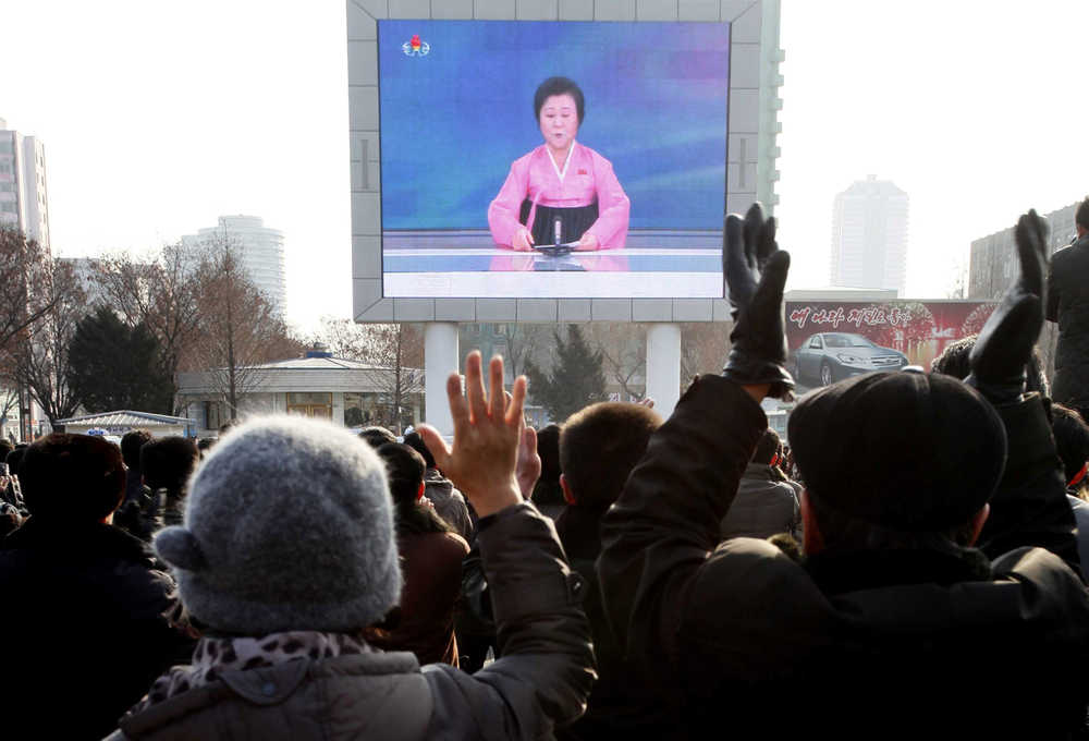 North Koreans watch a news broadcast outside Pyongyang Railway Station on Wednesday.