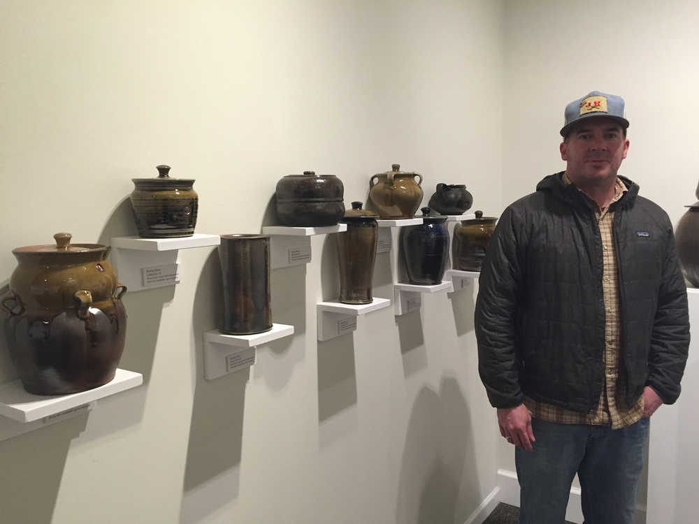 University of Alaska, Southeast associate professor of art Jeremy Kane stands with some of his creations for "Surface," a current show at the Juneau-Douglas City Museum.